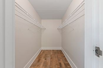 Walk-in closet with wire shelving on both sides